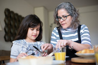 Mother with child at dining table 