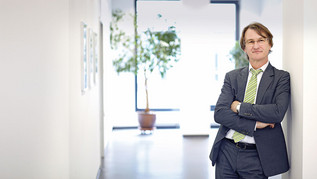 Wolfgang Ahrens is standing in a hallway.