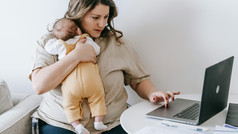 Young mother with child in her arms. 