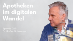 The image shows the title “Pharmacies in the digital transformation” in large white lettering against a gray background. A middle-aged man can be seen in profile on the right of the picture, wearing a blue top and sitting in front of a microphone. In the foreground, medicines can be seen out of focus, referring to the pharmacy world. Underneath it says: “Episode 022: Dr. Stefan Schwenzer”.