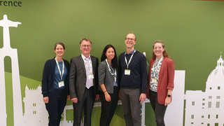 Fünf Personen stehen vor einer Stellwand der EUPHA.