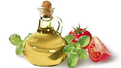 Flasche Öl mit Basilikum und Tomaten daneben
